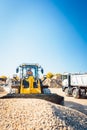 Construction workers doing earthworks with wheel loader