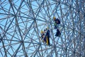 Construction workers doing maintenance job on the steel bars of the biosphere environment museum in Montreal, Quebec, Canada