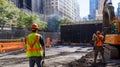 Construction Workers and Excavator at a City Construction Site Royalty Free Stock Photo