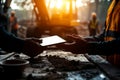 Construction workers exchanging tablet in sunlit worksite, showcasing teamwork and technology in construction industry Royalty Free Stock Photo