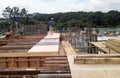 Construction workers fabricated timber formwork and reinforcement bar.