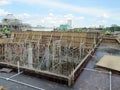 Construction workers fabricated timber formwork and reinforcement bar.