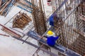 Construction workers fabricating large steel bar reinforcement bar at the in construction area building site