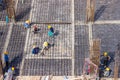 Construction workers fabricating large steel bar reinforcement bar at the in construction area building site Royalty Free Stock Photo