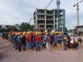 Construction workers gathered in the open space at the construction site to hear morning talks.