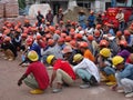 Construction workers gathered in the open space at the construction site to hear morning talks.