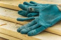 Workers gloves on a wood carpentry board