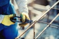 construction workers hands securing steel bars with wire rod for reinforcement of concrete Royalty Free Stock Photo