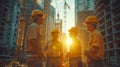 Construction workers in hard hats meet and discuss at a building site during sunset, emphasizing teamwork and planning Royalty Free Stock Photo