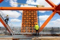 Construction workers on a high-rise building site with a crane and blue sky Royalty Free Stock Photo