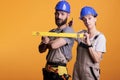 Construction workers holding screwdriver and water level Royalty Free Stock Photo