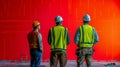 Construction Workers Inspecting a Red Wall Royalty Free Stock Photo