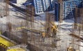 Construction workers install formwork and iron rebars or reinforcing bar for reinforced concrete partitions at the construction
