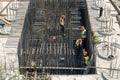 Construction workers install rebar for new building