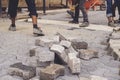 Construction workers installing and arranging precast concrete pavers stone for road. Royalty Free Stock Photo