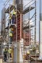 Construction workers installing concrete pillar mold