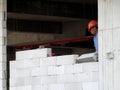 Construction workers installing lightweight block bricks to become wall at the construction site. Royalty Free Stock Photo