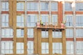 Construction workers insulating house facade with mineral rock wool installation. External wall insulation system or EWIS minera