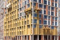 Construction workers insulating house facade with mineral rock wool installation.