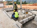 Construction workers laying autoclaved aerated concrete block at the construction site.