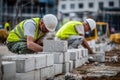 Construction Workers Laying Concrete Blocks for Foundation Royalty Free Stock Photo