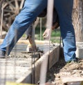 Construction workers leveling concrete pavement. Royalty Free Stock Photo