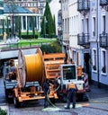 Construction workers make repair urban engineering. Replacement of cable laying modern optical communication Royalty Free Stock Photo