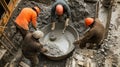 Construction Workers Mixing Concrete in a Trench Royalty Free Stock Photo