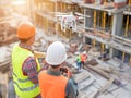 Construction Workers Operating Drone at Site Royalty Free Stock Photo