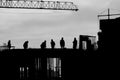 Silhouette of construction workers outdoors at sunset Royalty Free Stock Photo
