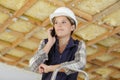 Construction workers on phone on ladder Royalty Free Stock Photo