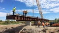 Construction Workers Placing a Bridge Beam with a Crane Royalty Free Stock Photo