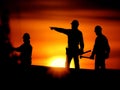Construction workers planning progress at building site sunset. Industrial and blue collar concept Royalty Free Stock Photo