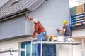 Construction workers plaster the facade of the house. Royalty Free Stock Photo