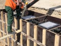 Construction workers are pooring concrete to formwork Royalty Free Stock Photo
