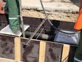 Construction workers are pooring concrete to formwork Royalty Free Stock Photo