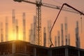 Construction workers pour concrete on the floor of a new residential building