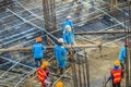 Construction workers are pouring concrete in post-tension flooring work. Mason workers carrying hose from concrete pump or also k Royalty Free Stock Photo