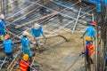 Construction workers are pouring concrete in post-tension flooring work. Mason workers carrying hose from concrete pump or also k Royalty Free Stock Photo
