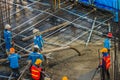 Construction workers are pouring concrete in post-tension flooring work. Mason workers carrying hose from concrete pump or also k Royalty Free Stock Photo