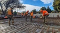 Construction Workers Pouring Concrete on Rebar Grid Royalty Free Stock Photo