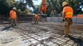 Construction Workers Pouring Concrete on a Rebar Grid Royalty Free Stock Photo