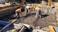 Construction Workers Pouring Concrete into a Rebar Grid Royalty Free Stock Photo