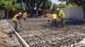 Construction Workers Pouring Concrete on a Rebar Grid Royalty Free Stock Photo