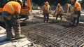 Construction Workers Pouring Concrete on a Rebar Grid Royalty Free Stock Photo