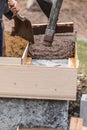 Construction Workers Pouring And Leveling Wet Cement Into Wood Framing Royalty Free Stock Photo