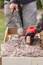 Construction Workers Pouring And Leveling Wet Cement Into Wood Framing Royalty Free Stock Photo