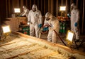 Construction workers in protective gear applying spray foam insulation indoors Royalty Free Stock Photo