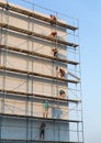 Construction workers putting decorative plaster on house exterior Royalty Free Stock Photo