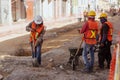 Construction workers repair a road in the Historic Center of Puebla